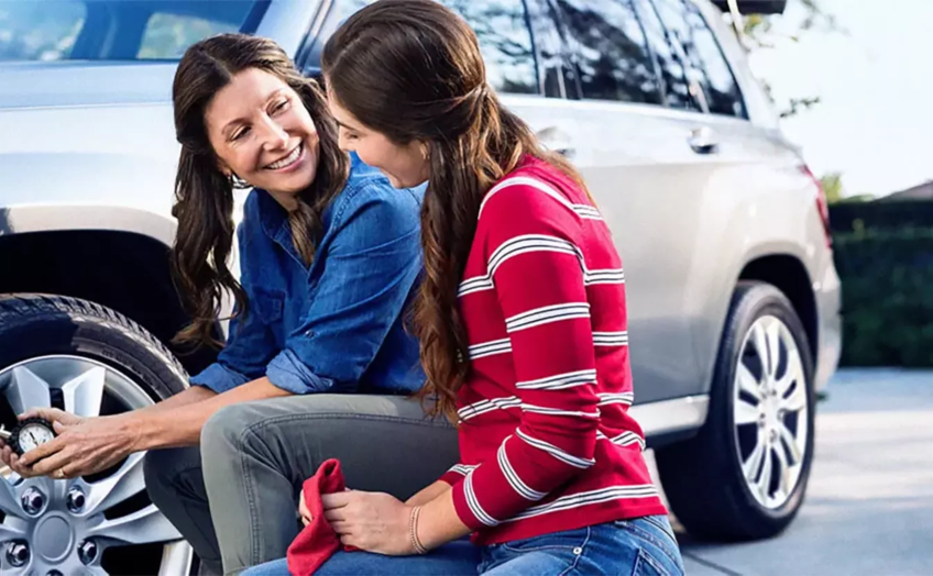 Famers Auto Insurance Mom and Daughter working on tire